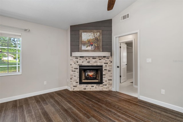 6095 W Douneray Loop, Crystal River, FL 34429 - unfurnished living room with vaulted ceiling, a ceiling fan, wood finished floors, a large fireplace, and visible vents