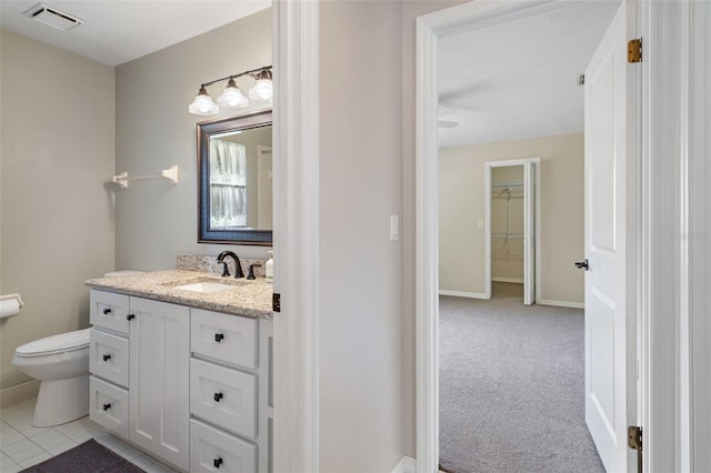 6095 W Douneray Loop, Crystal River, FL 34429 - bathroom featuring baseboards, visible vents, toilet, and vanity