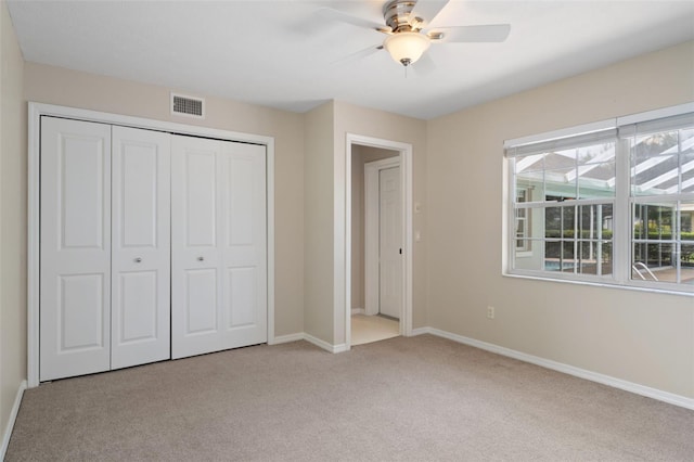 6095 W Douneray Loop, Crystal River, FL 34429 - unfurnished bedroom with baseboards, visible vents, a closet, ceiling fan, and carpet floors