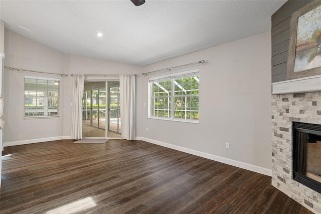 6095 W Douneray Loop, Crystal River, FL 34429 - unfurnished living room with a fireplace, lofted ceiling, baseboards, and dark wood-style flooring