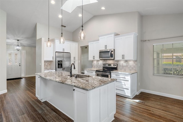 6095 W Douneray Loop, Crystal River, FL 34429 - kitchen featuring stainless steel appliances, a sink, a skylight, a center island with sink, and decorative backsplash
