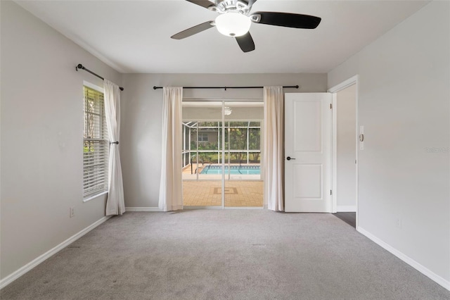 6095 W Douneray Loop, Crystal River, FL 34429 - empty room with plenty of natural light, carpet flooring, and ceiling fan