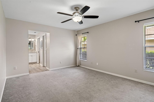 6095 W Douneray Loop, Crystal River, FL 34429 - spare room featuring baseboards, a ceiling fan, and light colored carpet