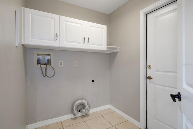 6095 W Douneray Loop, Crystal River, FL 34429 - laundry room featuring hookup for a washing machine, electric dryer hookup, light tile patterned floors, cabinet space, and baseboards