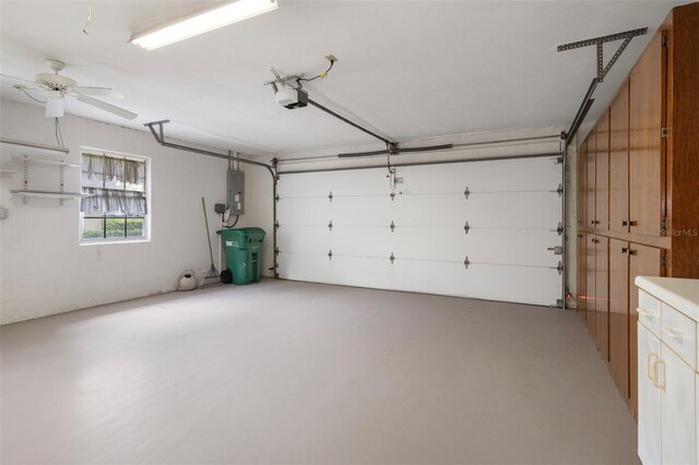 6095 W Douneray Loop, Crystal River, FL 34429 - garage featuring a garage door opener, electric panel, and ceiling fan