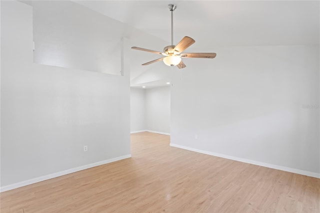 empty room with vaulted ceiling, baseboards, light wood-style floors, and ceiling fan