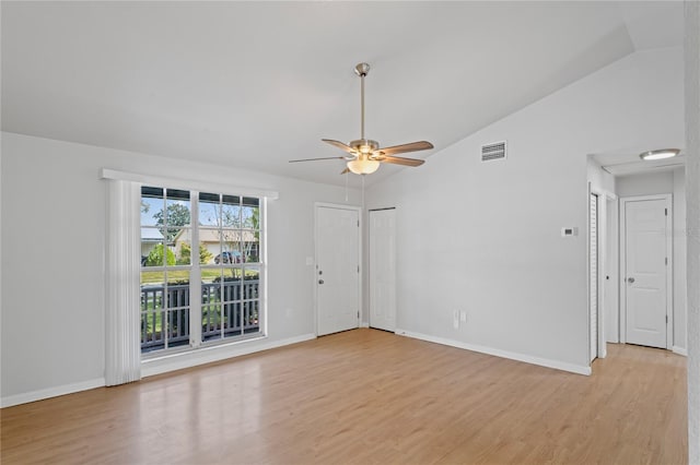 empty room featuring light wood-style floors, visible vents, a ceiling fan, and baseboards