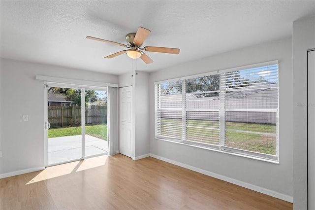 spare room featuring baseboards, a ceiling fan, and wood finished floors