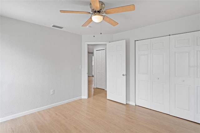unfurnished bedroom with light wood-type flooring, baseboards, and visible vents