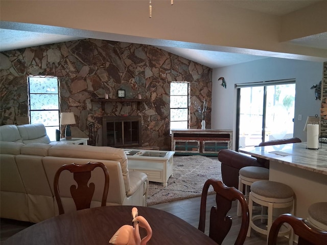 7508 Cypress Knee Dr, Hudson, FL 34667 - living area with vaulted ceiling, wood finished floors, and a fireplace