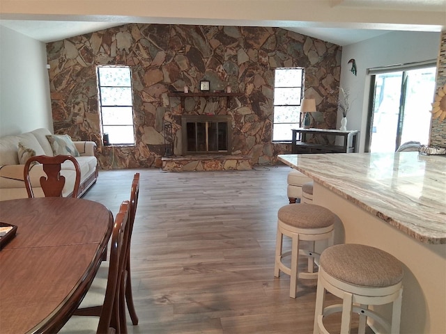 7508 Cypress Knee Dr, Hudson, FL 34667 - dining room with wood finished floors, plenty of natural light, and a stone fireplace