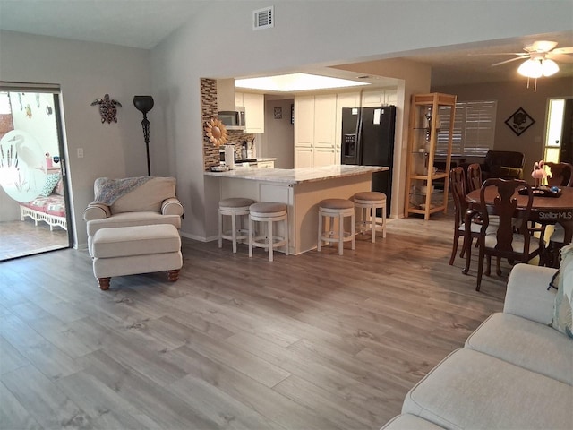 7508 Cypress Knee Dr, Hudson, FL 34667 - living room featuring ceiling fan, lofted ceiling, and light wood-style flooring