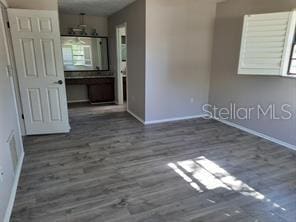 7508 Cypress Knee Dr, Hudson, FL 34667 - unfurnished room featuring baseboards and wood finished floors