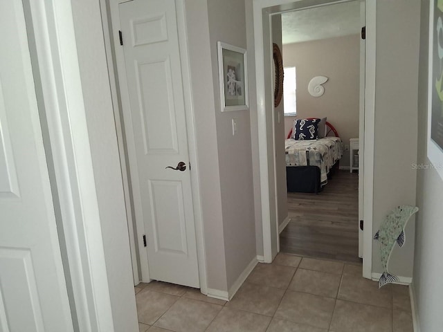 7508 Cypress Knee Dr, Hudson, FL 34667 - hallway with light tile patterned floors and baseboards