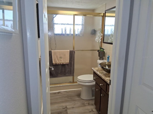 7508 Cypress Knee Dr, Hudson, FL 34667 - full bath with vanity, wood finished floors, a stall shower, a textured ceiling, and a water view