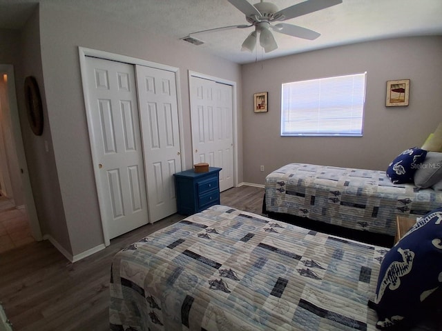 7508 Cypress Knee Dr, Hudson, FL 34667 - bedroom featuring multiple closets, wood finished floors, and ceiling fan
