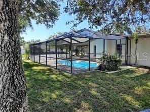 7508 Cypress Knee Dr, Hudson, FL 34667 - outdoor pool with a yard and a lanai