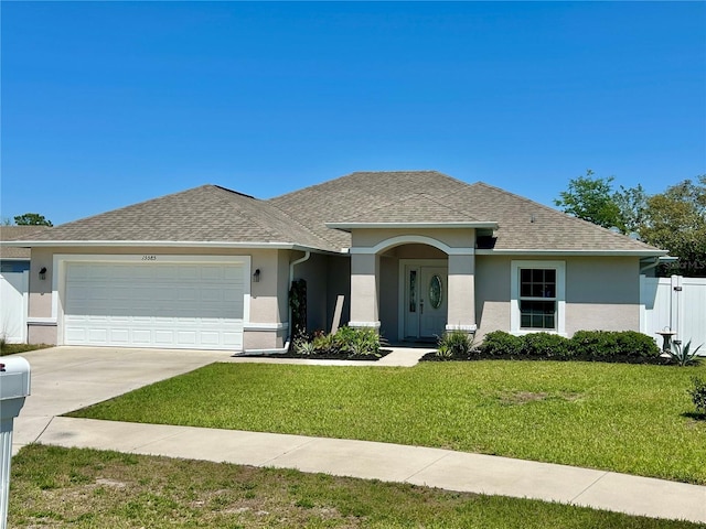 ranch-style house with stucco siding, fence, a front yard, and a garage
