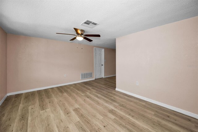 7321 Parrot Dr, Port Richey, FL 34668 - empty room featuring baseboards, a ceiling fan, visible vents, and light wood-style floors