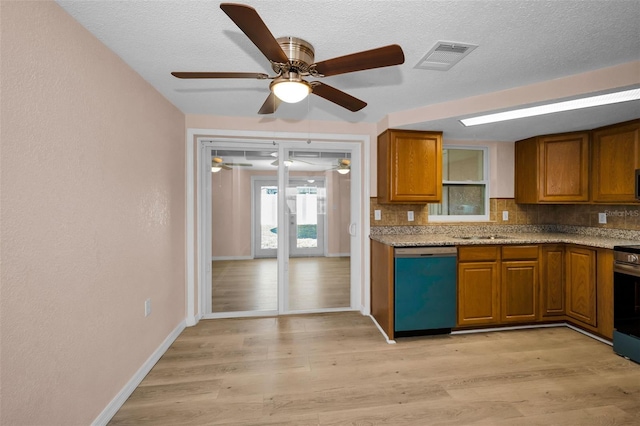 7321 Parrot Dr, Port Richey, FL 34668 - kitchen with stainless steel appliances, backsplash, visible vents, brown cabinetry, and ceiling fan