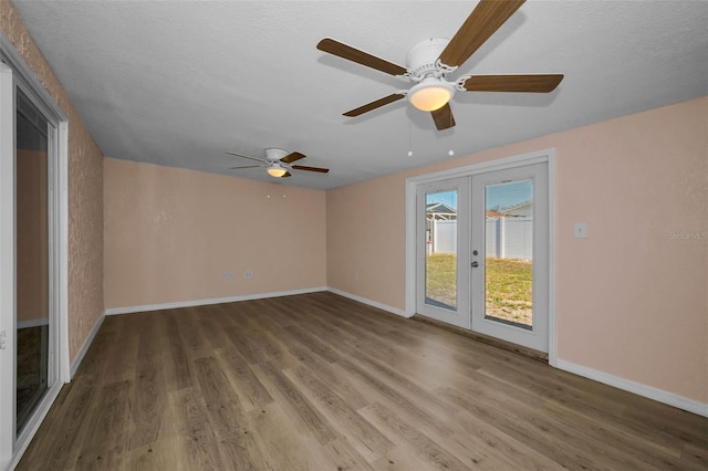 7321 Parrot Dr, Port Richey, FL 34668 - spare room featuring wood finished floors, a ceiling fan, baseboards, and french doors