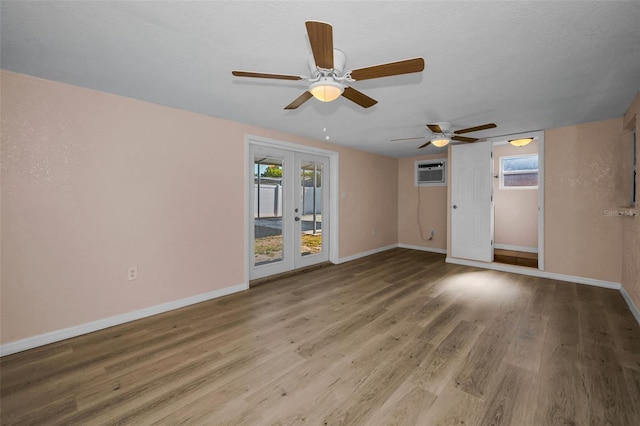 7321 Parrot Dr, Port Richey, FL 34668 - spare room with baseboards, a wealth of natural light, ceiling fan, and a wall mounted air conditioner