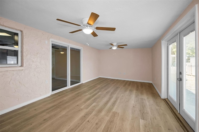 7321 Parrot Dr, Port Richey, FL 34668 - spare room with light wood-type flooring, a ceiling fan, and baseboards