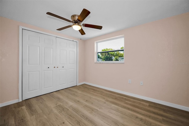 7321 Parrot Dr, Port Richey, FL 34668 - unfurnished bedroom featuring light wood-style flooring, baseboards, a closet, and ceiling fan