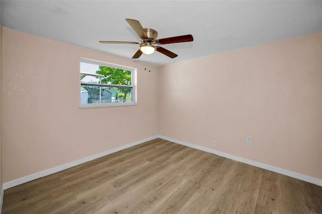 7321 Parrot Dr, Port Richey, FL 34668 - empty room with light wood-type flooring, a ceiling fan, and baseboards