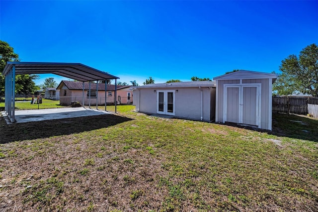 7321 Parrot Dr, Port Richey, FL 34668 - rear view of property featuring fence, a yard, stucco siding, french doors, and a detached carport
