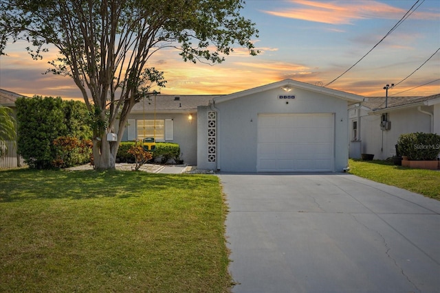 5106 Blue Heron Dr, New Port Richey, FL 34652 - ranch-style house with a front yard, concrete driveway, a garage, and stucco siding