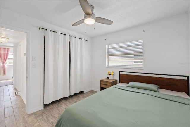 5106 Blue Heron Dr, New Port Richey, FL 34652 - bedroom with baseboards, ceiling fan, and light wood-style flooring