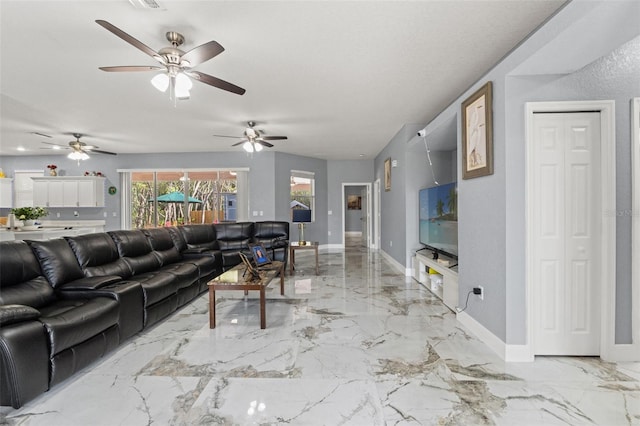 living room with baseboards, ceiling fan, visible vents, and marble finish floor