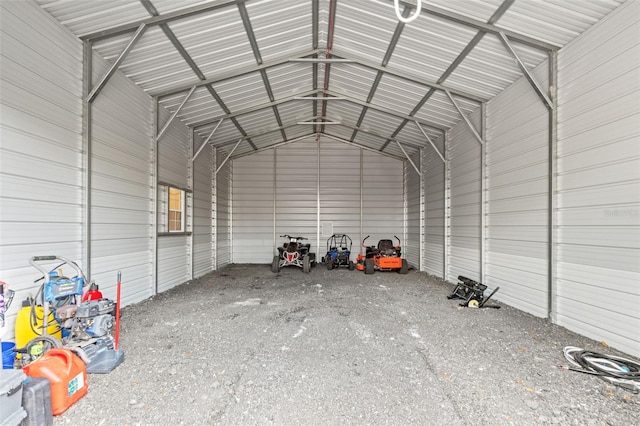 misc room featuring vaulted ceiling and metal wall