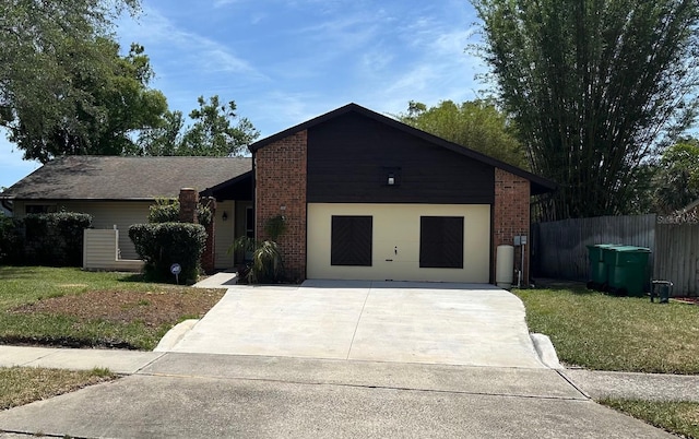 1412 Wexford Dr N, Palm Harbor, FL 34683 - view of front of home with fence, an attached garage, driveway, and brick siding