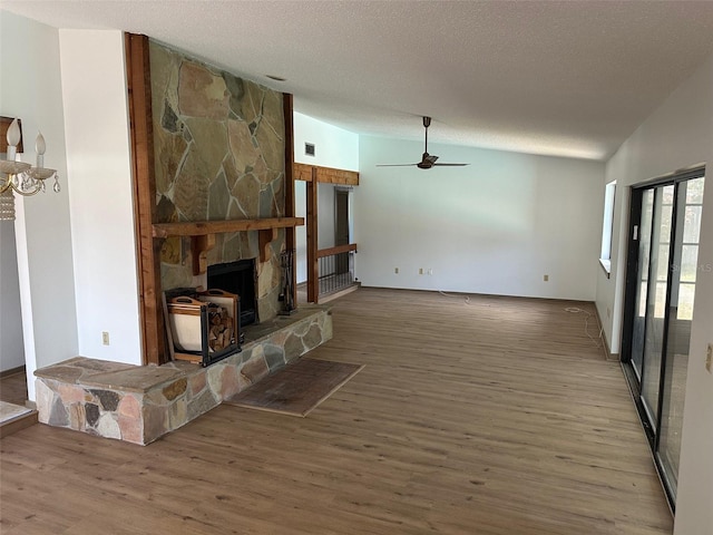 1412 Wexford Dr N, Palm Harbor, FL 34683 - unfurnished living room featuring ceiling fan, a textured ceiling, visible vents, wood finished floors, and lofted ceiling