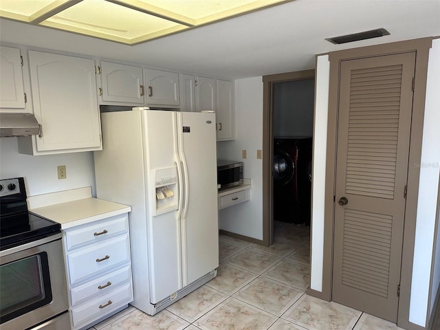 1412 Wexford Dr N, Palm Harbor, FL 34683 - kitchen with visible vents, light countertops, light tile patterned floors, under cabinet range hood, and stainless steel appliances