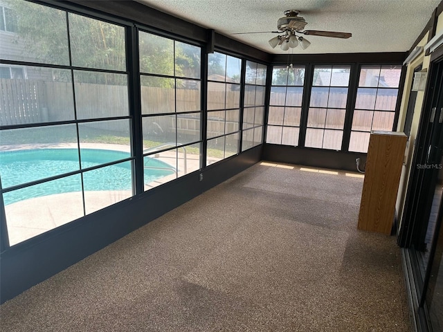 1412 Wexford Dr N, Palm Harbor, FL 34683 - unfurnished sunroom featuring a healthy amount of sunlight, carpet, and a textured ceiling