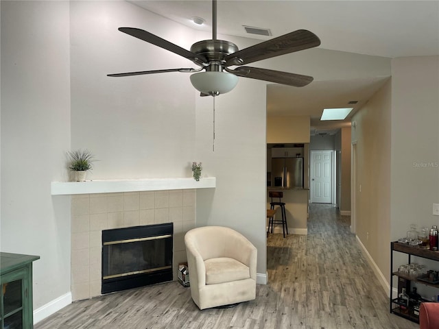 2729 Penzance St, Palm Harbor, FL 34684 - living area featuring visible vents, wood finished floors, a fireplace, baseboards, and ceiling fan