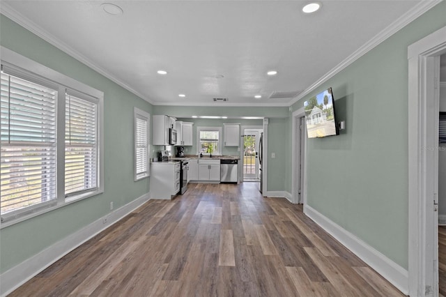 unfurnished living room featuring baseboards, dark wood-type flooring, and recessed lighting