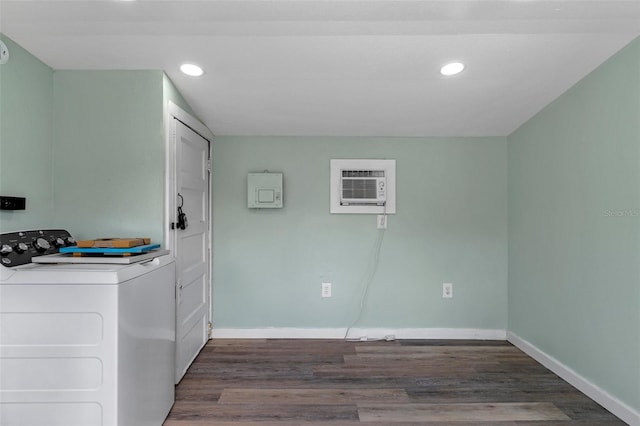 washroom featuring dark wood finished floors, an AC wall unit, washer / dryer, and baseboards