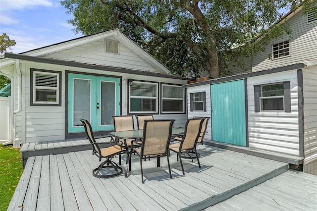 deck with an outdoor structure and outdoor dining space