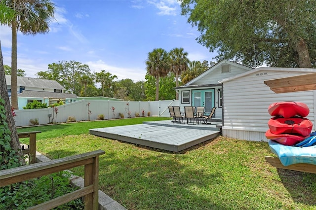 view of yard featuring a wooden deck, french doors, and a fenced backyard