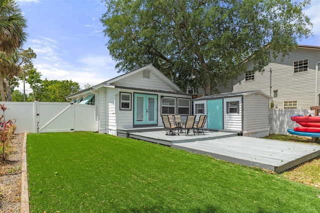 rear view of house featuring fence, french doors, a gate, and a deck