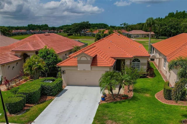 mediterranean / spanish home featuring a garage, a tiled roof, driveway, and stucco siding