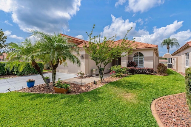mediterranean / spanish-style house with driveway, an attached garage, stucco siding, a tile roof, and a front yard