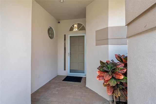 entrance to property featuring stucco siding