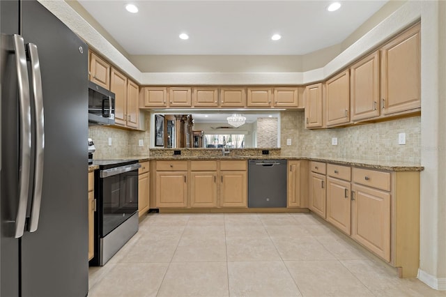 kitchen with stainless steel appliances, light brown cabinets, light stone countertops, and recessed lighting