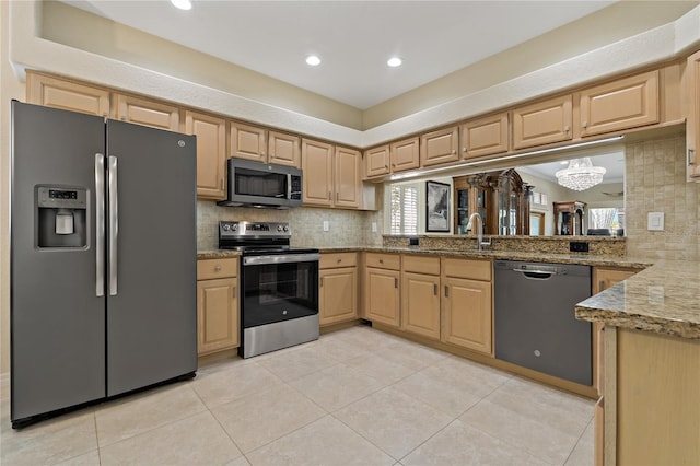 kitchen with stainless steel appliances, light brown cabinetry, light tile patterned floors, backsplash, and light stone countertops