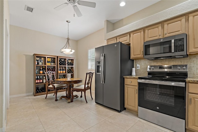 kitchen with appliances with stainless steel finishes, tasteful backsplash, a ceiling fan, light tile patterned floors, and light brown cabinetry